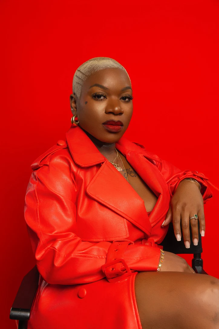 Intimacy Redefined founder in a vibrant red leather jacket